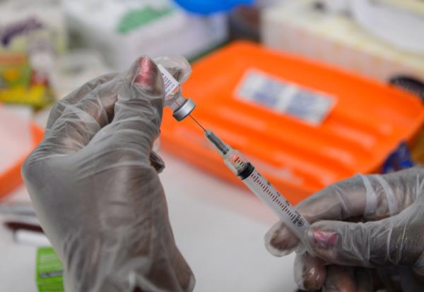 A school nurse preapres a vaccine against whooping cough before giving it to students at Mark Twain Middle School August 7, 2012 in Los Angeles, California.