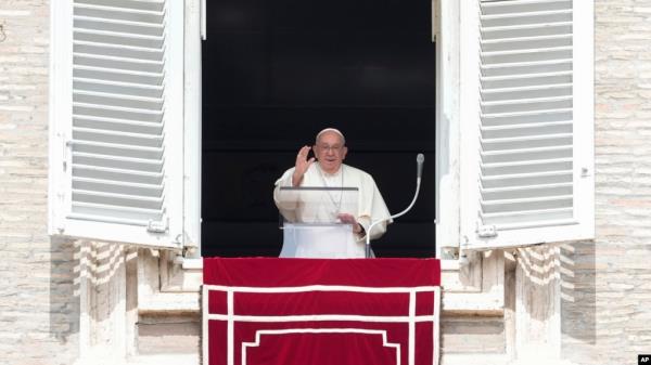 Pope Francis waves during the Angelus noon prayer from the window of his studio overlooking St. Peter's Square, at the Vatican, Sept. 22, 2024. The pope will be traveling to Luxembourg and Belgium Sept. 26-29. 