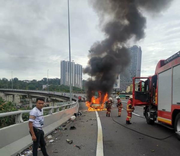 Skidding car bursts into flames on New Pantai Expressway, killing driver and injuring passenger, says Fire Dept