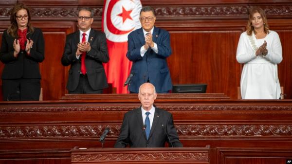 In this photo provided by the Tunisian Presidency, Tunisia's President Kais Saied is applauded after taking oath October 21, 2024 in Tunis following his reelection. 