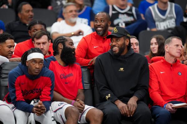 Clippers' James Harden, center left, shares a light moment with Kawhi Leonard.