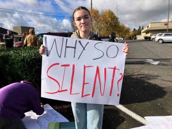 Alayna Mathieson, a ninth grade student at St. Helens, holding up a sign at the protest.